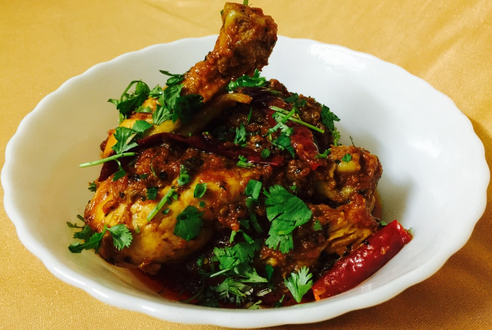 Indian chicken curry with raw spices 